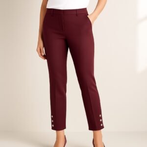 Front view of model wearing burgundy Ann Taylor Petite Ankle Pants with gold button details at the ankle, shown on a white background.