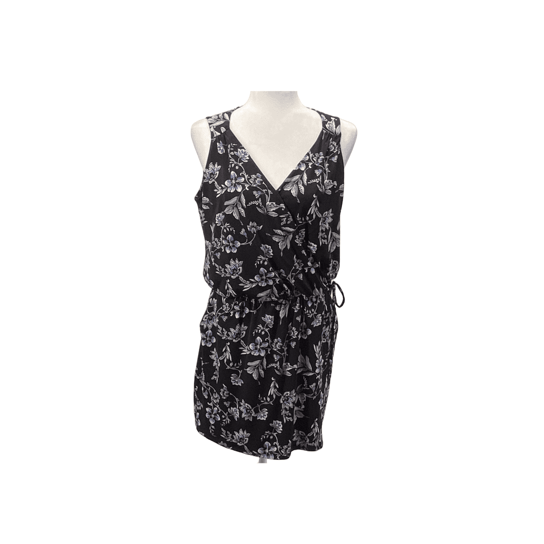 A photo of a White House Black Market Black romper with a floral print.