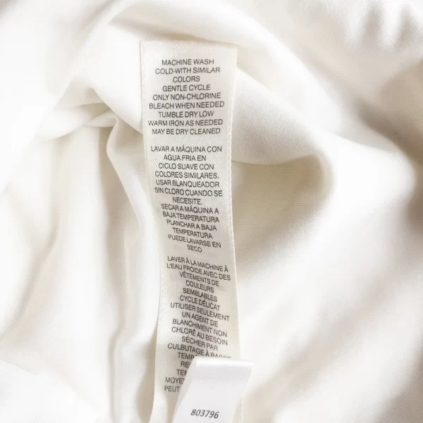 A photo of a Peplum Sleeveless Top White Cream White House Black Market Care Label