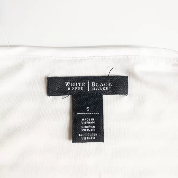 A photo of the White House Black Market tag and size tag