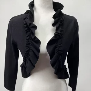 Front view of a black ruffle shrug cardigan by White House Black Market, displayed on a mannequin, featuring an open front, ruffle trim, 3/4 sleeves, and cropped silk-blend design in size medium