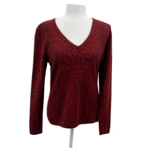 Neiman Marcus Cashmere Leopard Print Sweater in bold red with black animal pattern, long-sleeve V-neck design, displayed on a mannequin against a neutral background highlighting its soft knit texture.